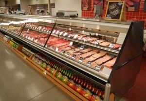 Borgen Systems Meat Case merchandised with beer and wine.